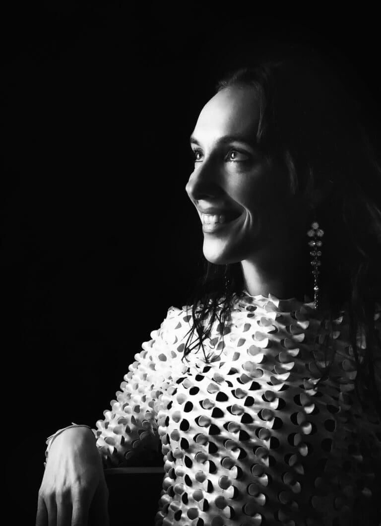 A self-portrait of Eline Kouijzer, 3D artist and founder of E-Line Vision, captured in a dramatic, Rembrandt-inspired lighting style. The image showcases Eline’s mastery in playing with light and shadow, reflecting her expertise in 3D visualizations and photorealistic renderings for architecture and interior design. Her work, executed with tools like 3ds Max and V-Ray, translates her deep understanding of texture and mood into tailored designs for residential and commercial projects. Eline’s portrait symbolizes her ability to bring depth and emotion to both digital and physical spaces, serving clients across Tubbergen, Twente, and beyond